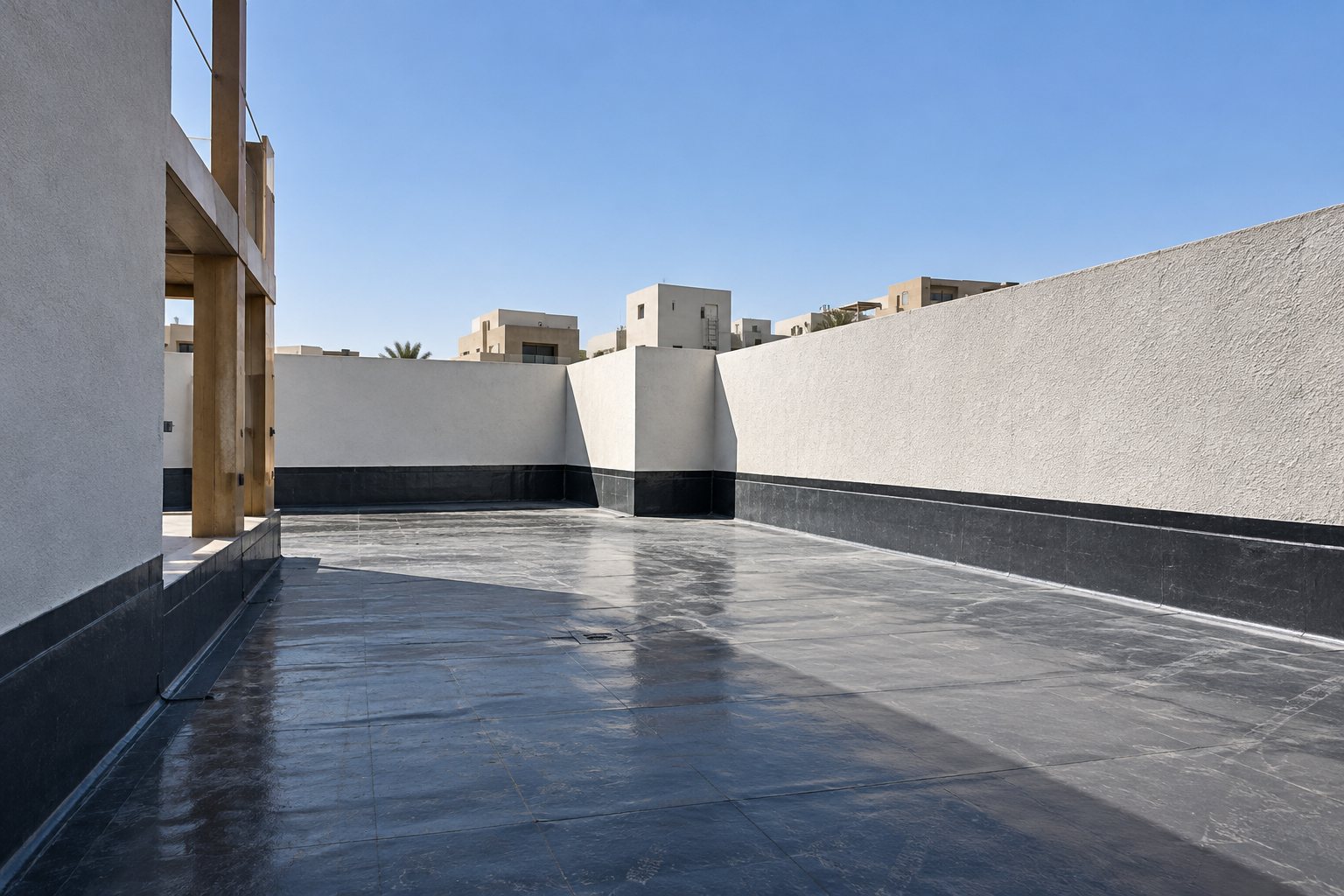 Roof terrace of a villa with waterproofing membrane applied across the slab and up the parapet walls